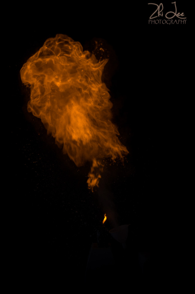 Cornflour dust in flames against a black backdrop
