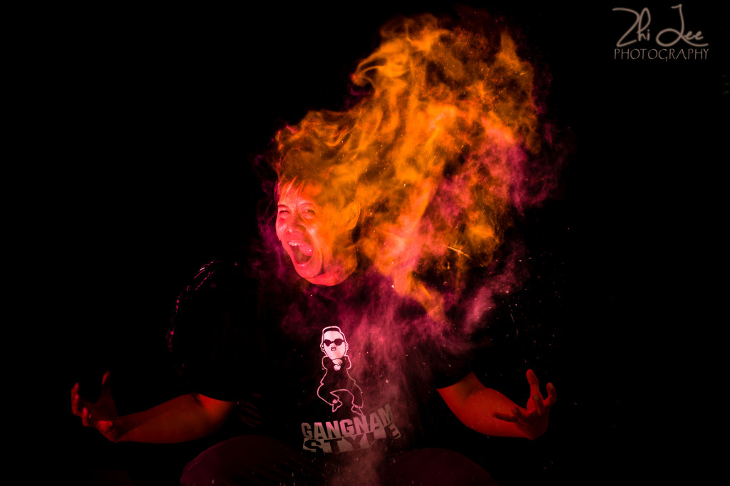 Creative Portrait lit with Fire and Red Flash Against a Black Backdrop. By Zhi Lee